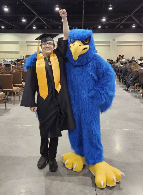 Thaddius Stemp posing with the Daytona State College mascot.